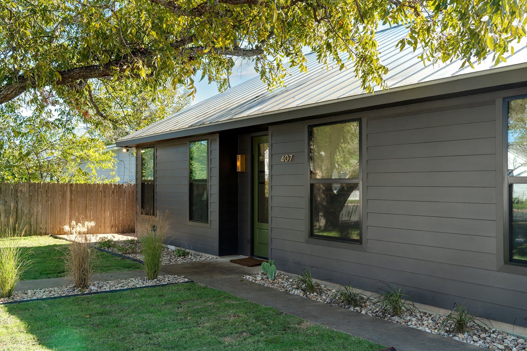 Green front door with brass sconces at Casa Alegre Fredericksburg Texas