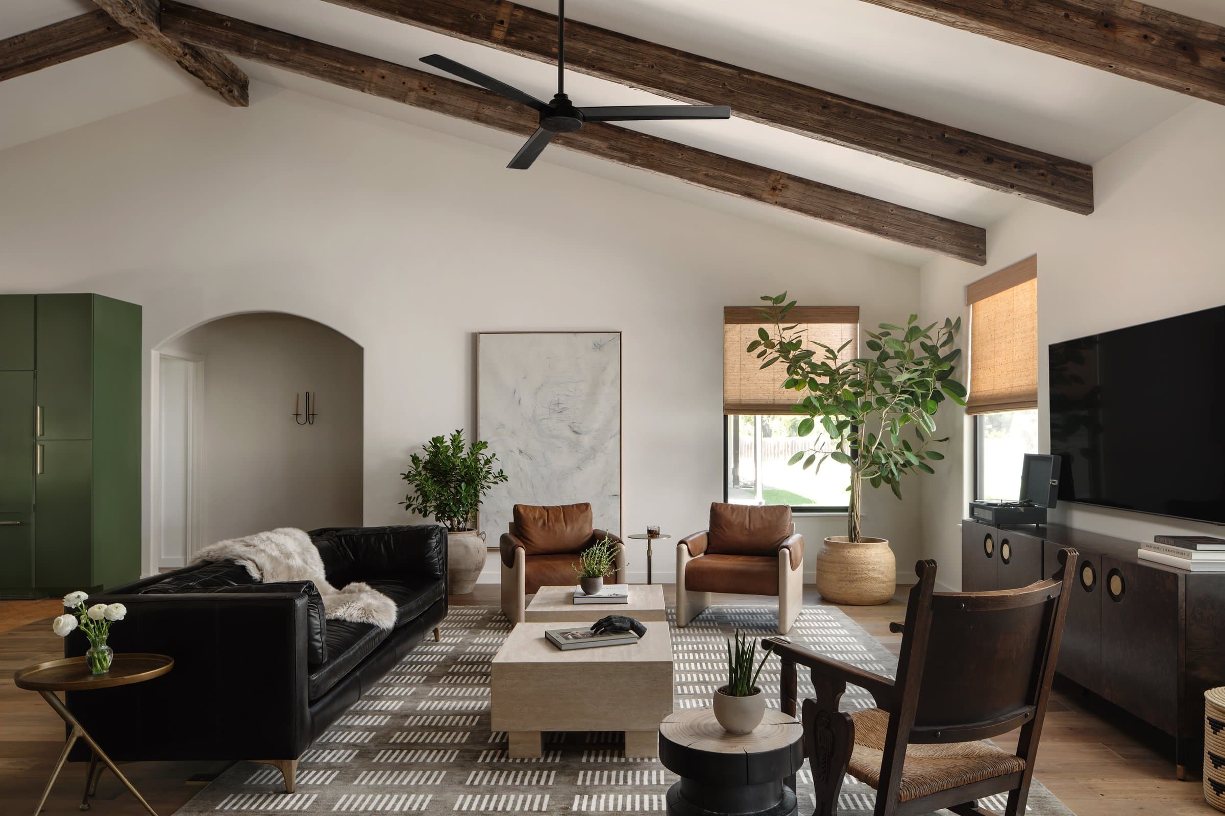 Living room with reclaimed timber ceiling and leather furniture at Casa Alegre Fredericksburg Texas