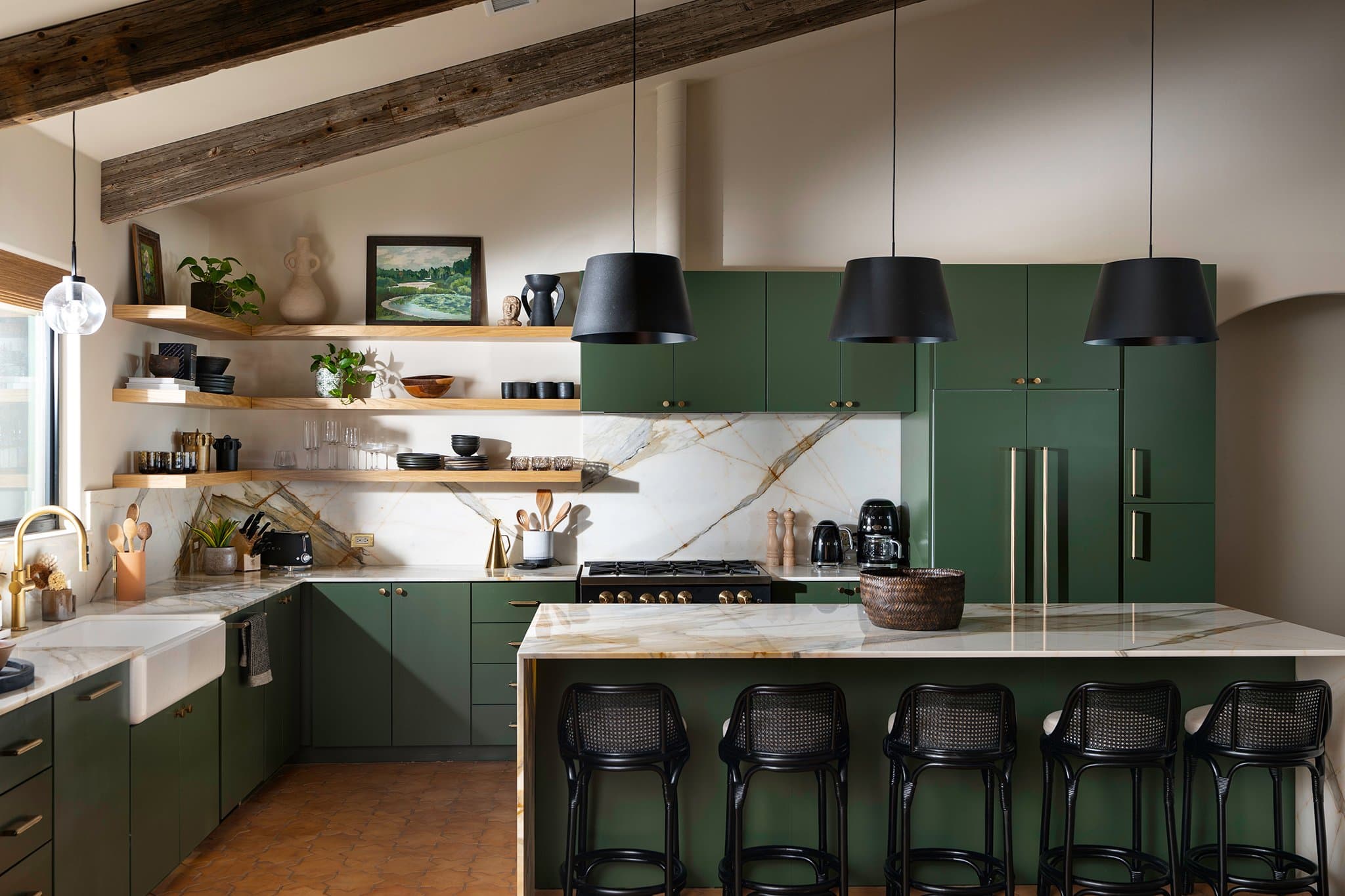 Gourmet kitchen with green cabinets and marble island at Casa Alegre Fredericksburg Texas