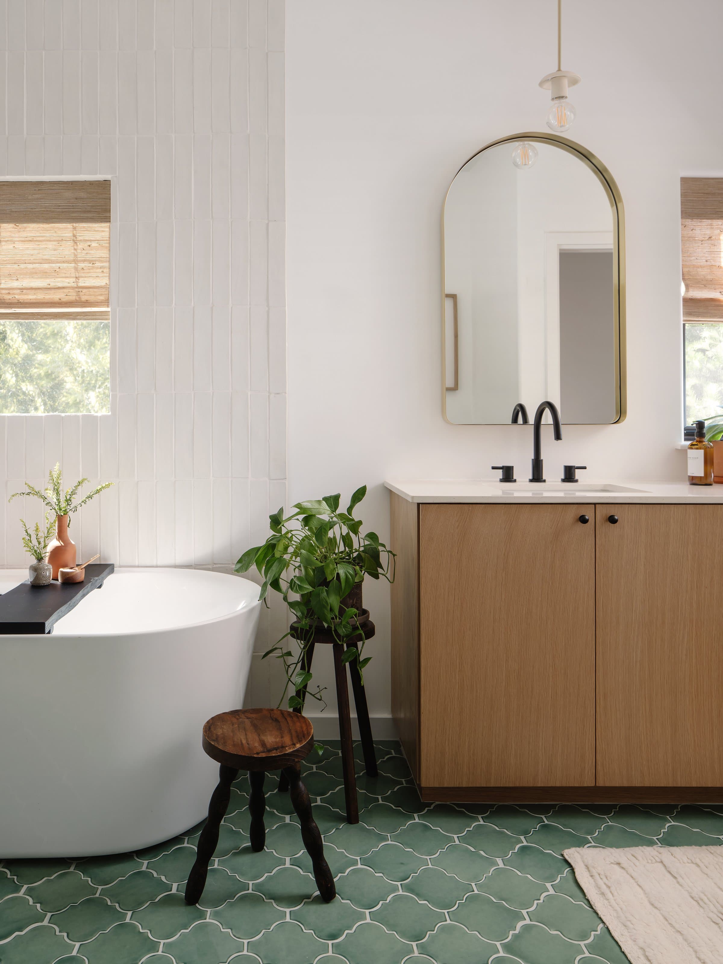 Master bathroom with soaking tub and green tile at Casa Alegre Fredericksburg Texas