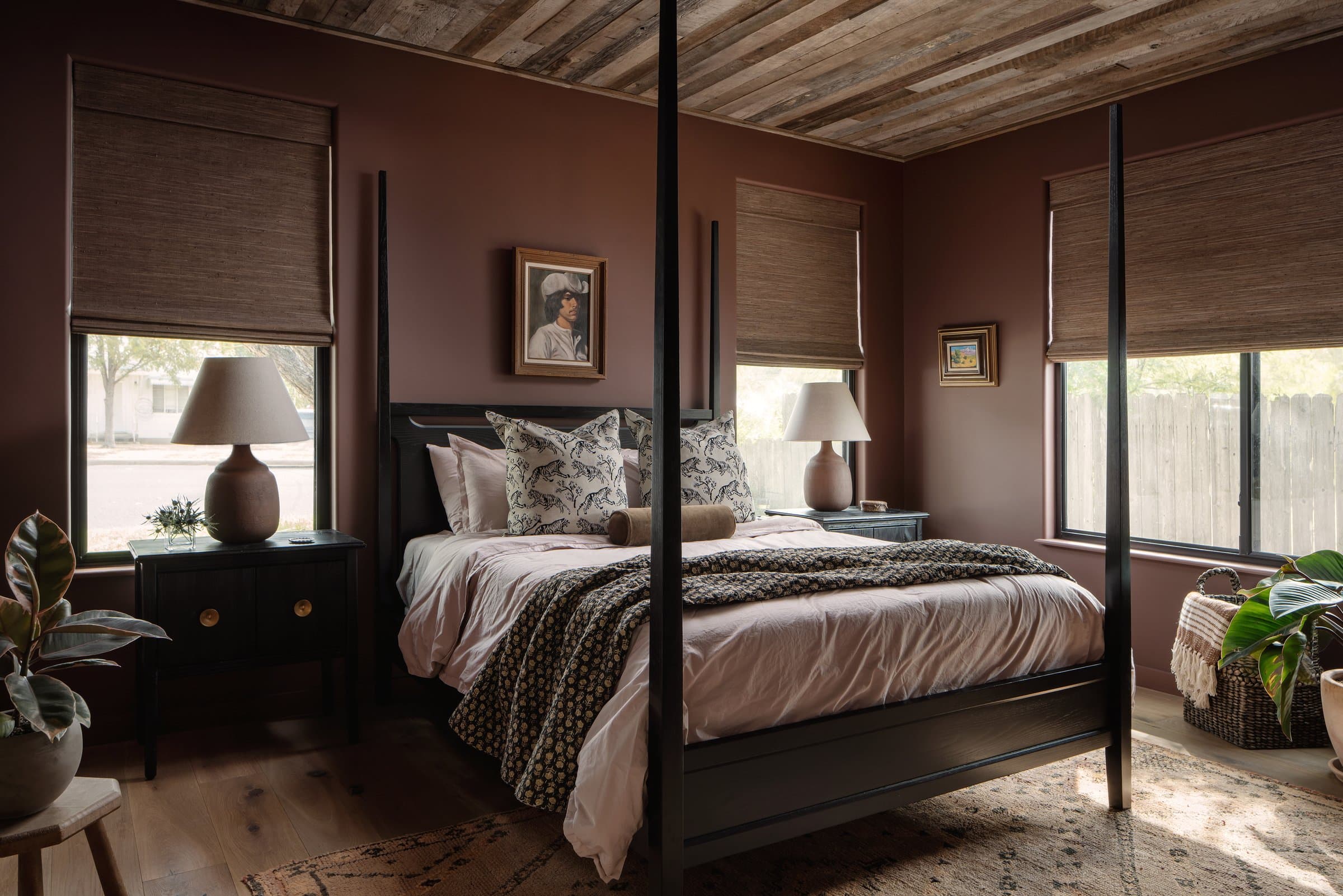 Moody bedroom with reclaimed timber ceiling at Casa Alegre Fredericksburg Texas